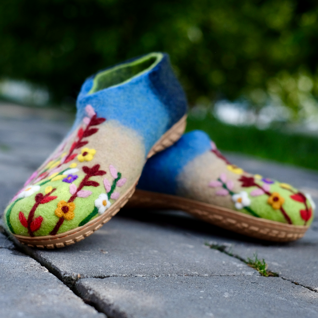 a pair of slippers sitting on top of a sidewalk